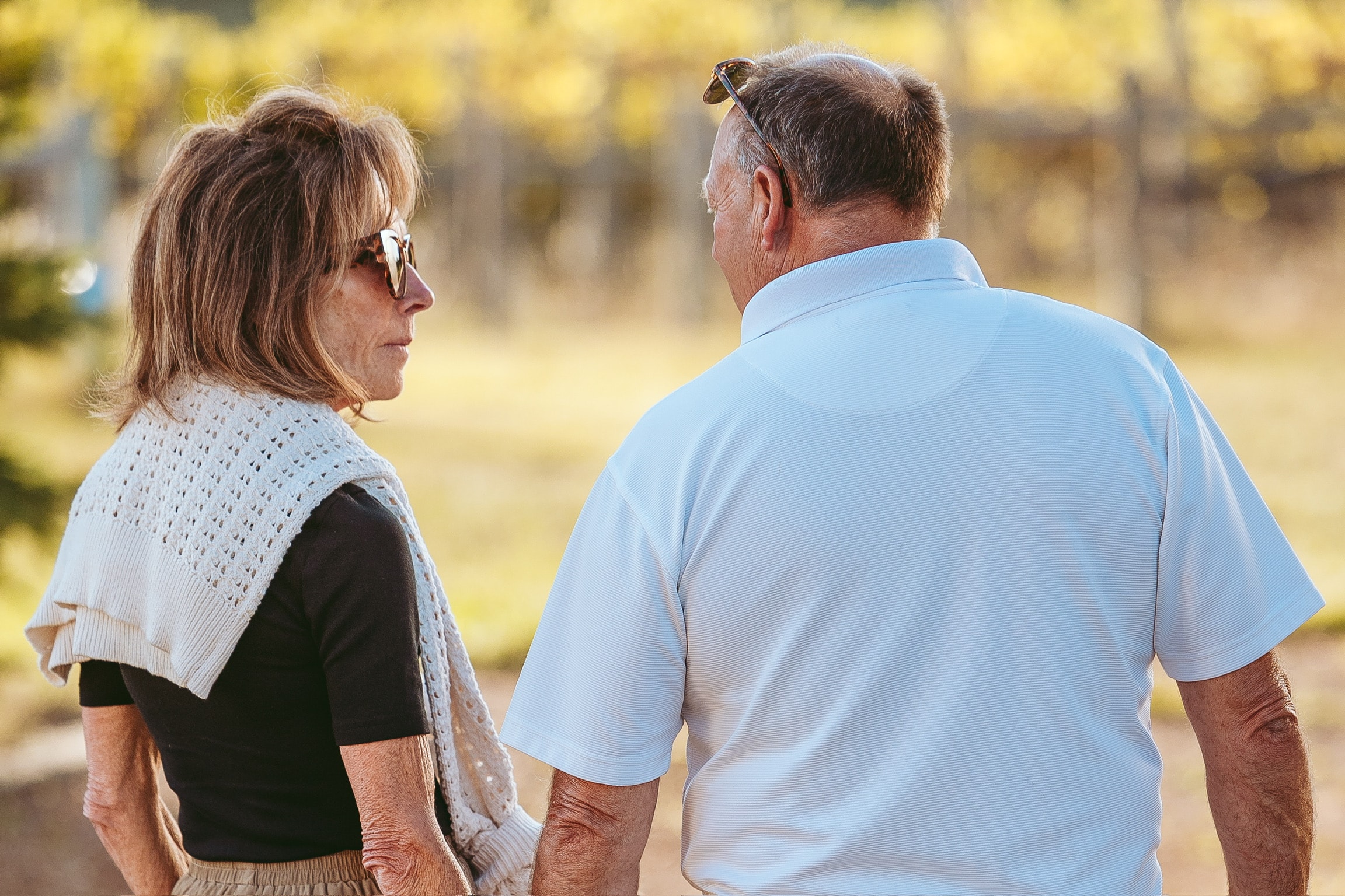 Couple in conversation by the vineyard